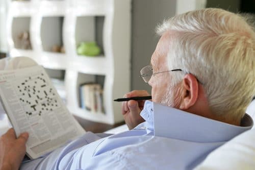 Older man doing crossword